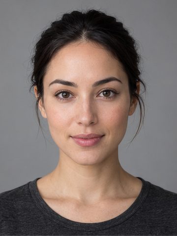 A fictional creator with dark hair tied back and a charcoal shirt against a gray background.
